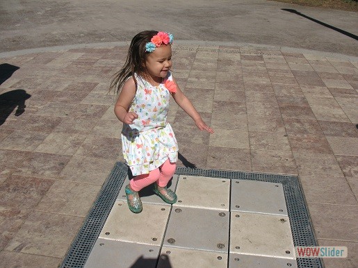 a girl is enjoying the sound sensory steps at the tactile playground